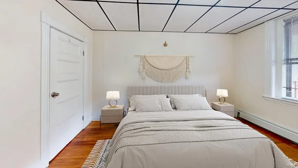 a bedroom with a bed and a window
