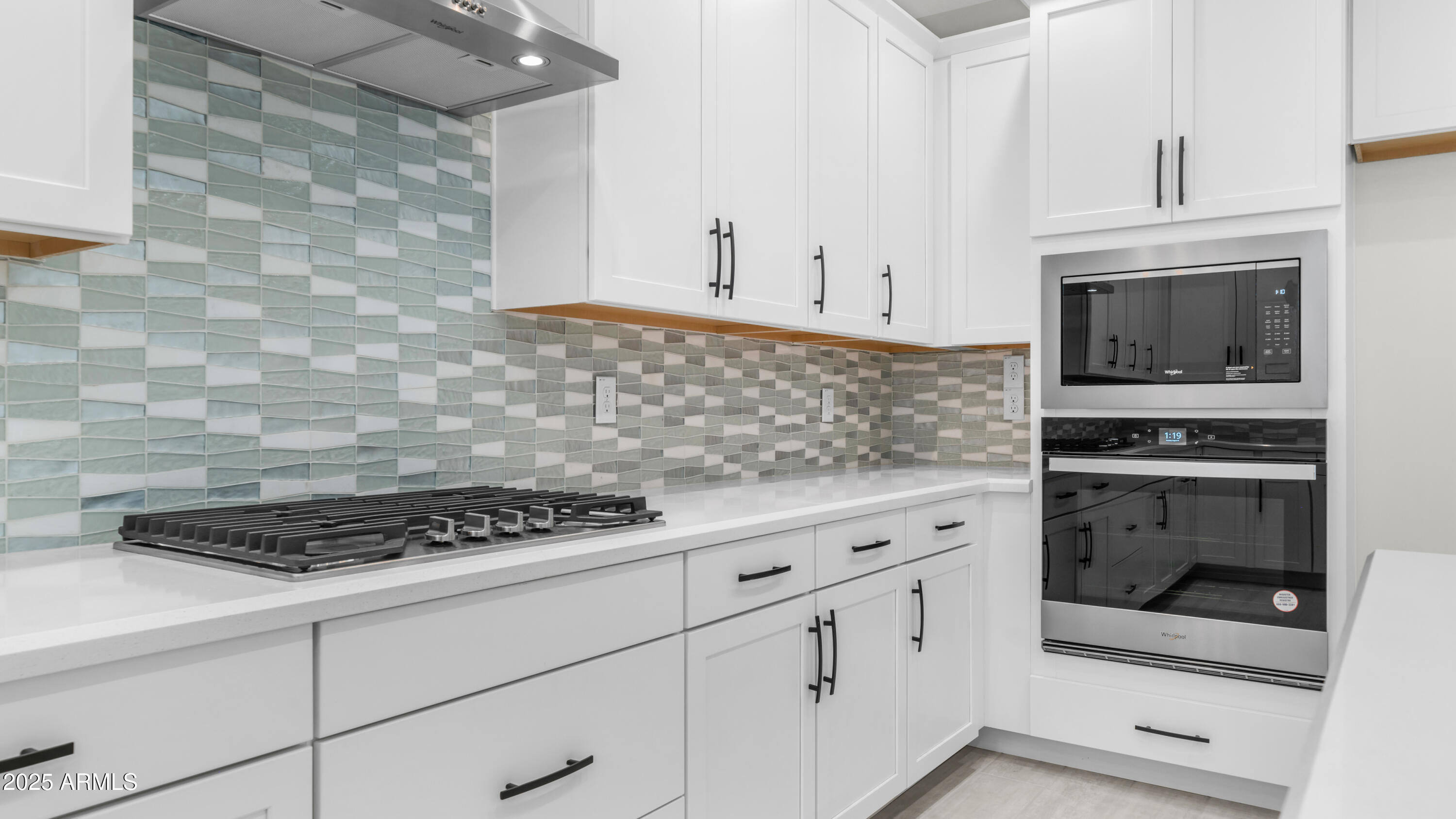 13359 West Eagle Feather Road Peoria, AZ 85383 - Photo 12 of 33 a kitchen with white cabinets and appliances