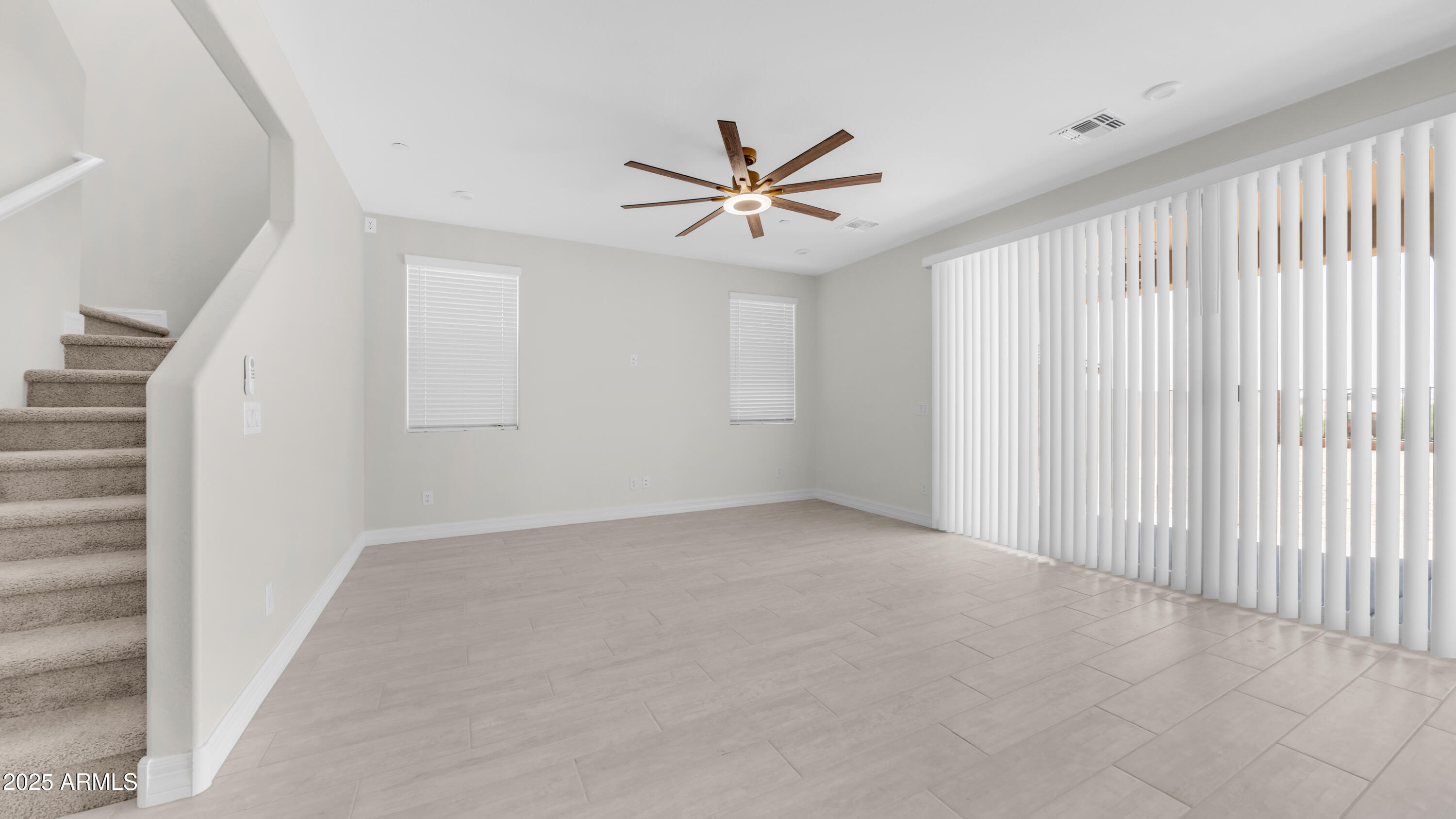 13359 West Eagle Feather Road Peoria, AZ 85383 - Photo 6 of 33 an empty room with windows and fan