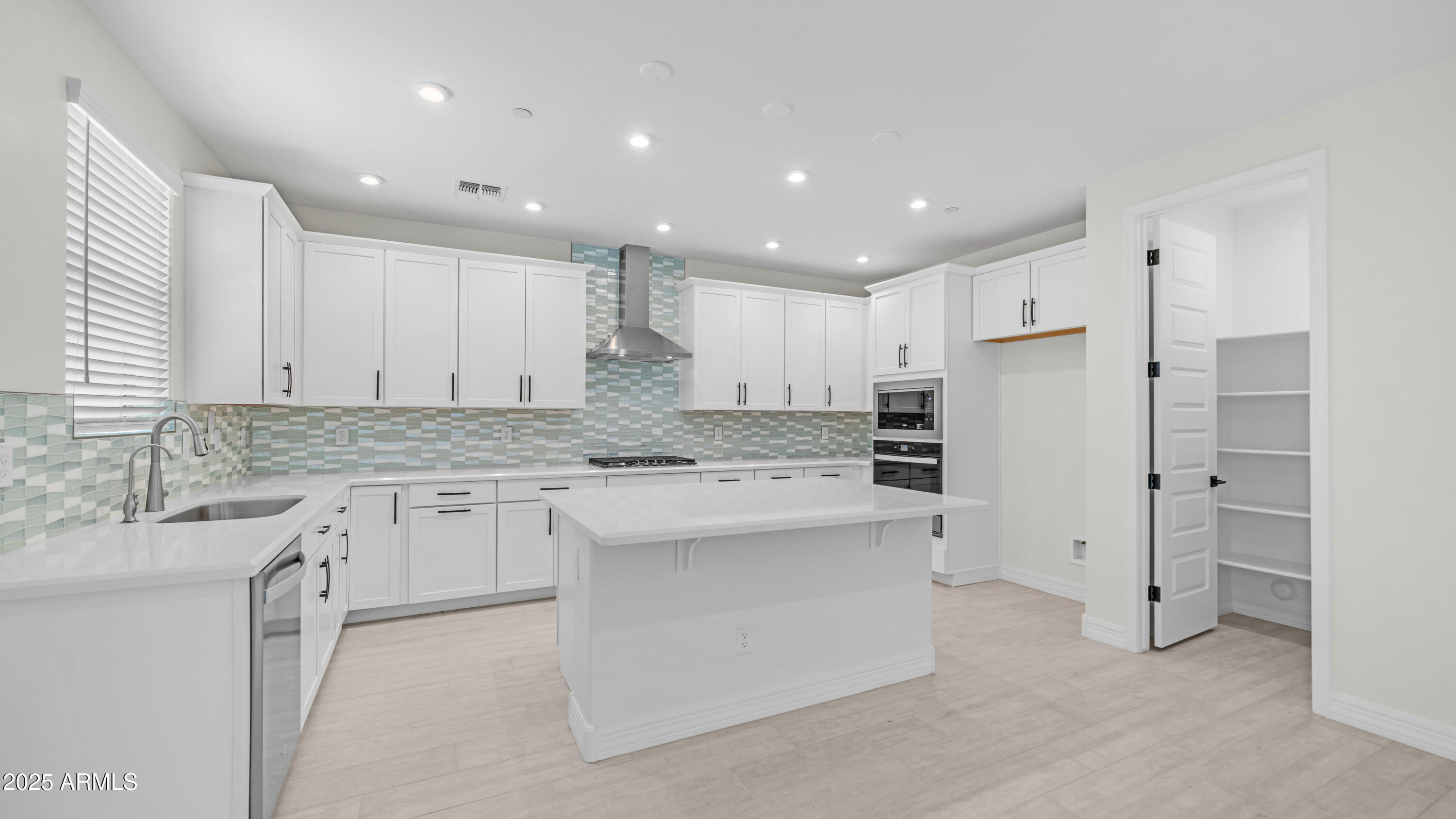 13359 West Eagle Feather Road Peoria, AZ 85383 - Photo 8 of 33 a kitchen with kitchen island a sink stainless steel appliances and cabinets