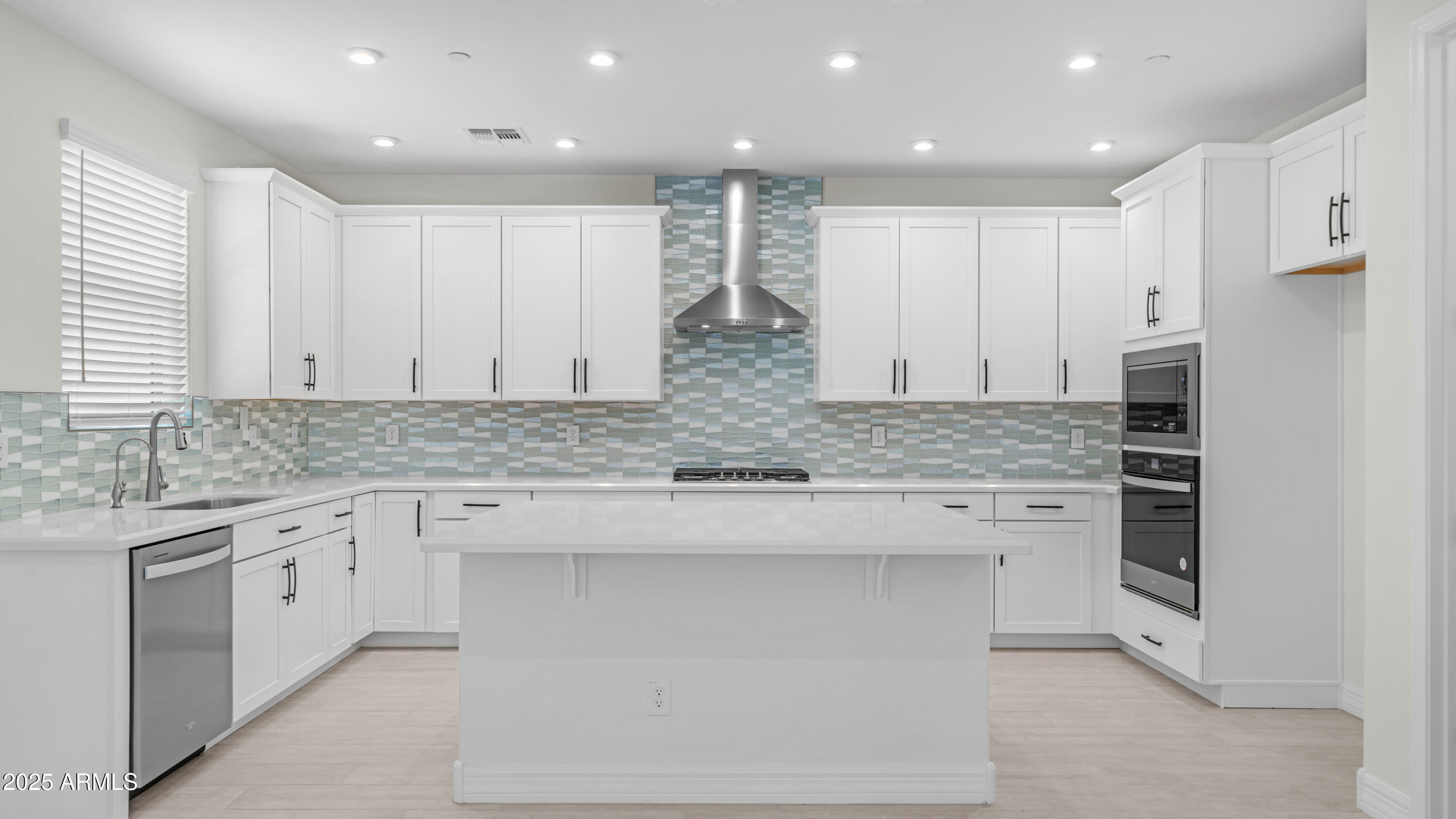 13359 West Eagle Feather Road Peoria, AZ 85383 - Photo 9 of 33 a kitchen with stainless steel appliances granite countertop a stove a sink and a refrigerator