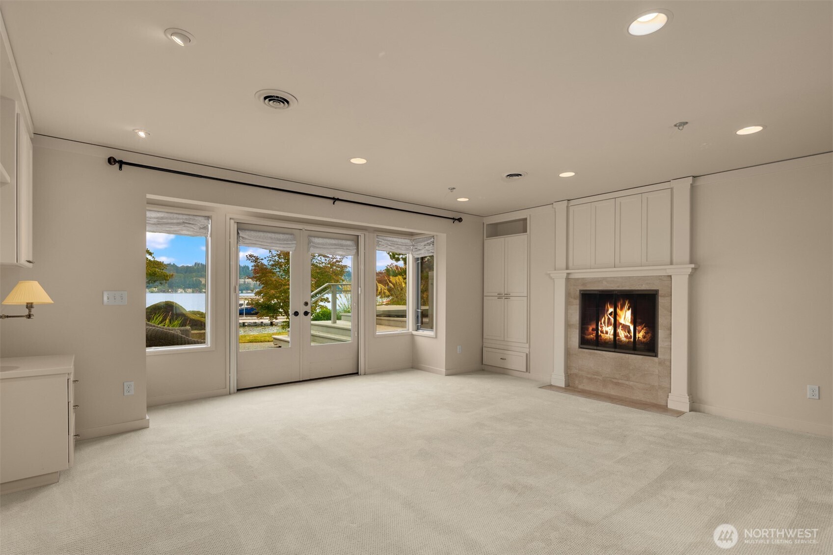 4802 East Mercer Way Mercer Island, WA 98040 - Photo 26 of 33 a large room with a fireplace and a large window