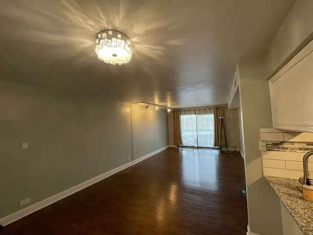 a view of livingroom and kitchen with wooden floor