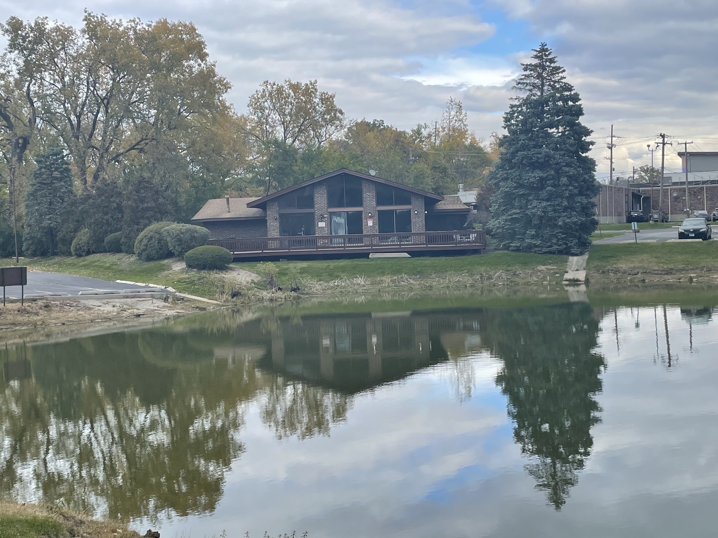830 Elder Road, Unit B303 Homewood, IL 60430 - Photo 6 of 6 a view of a lake with a yard next to a building