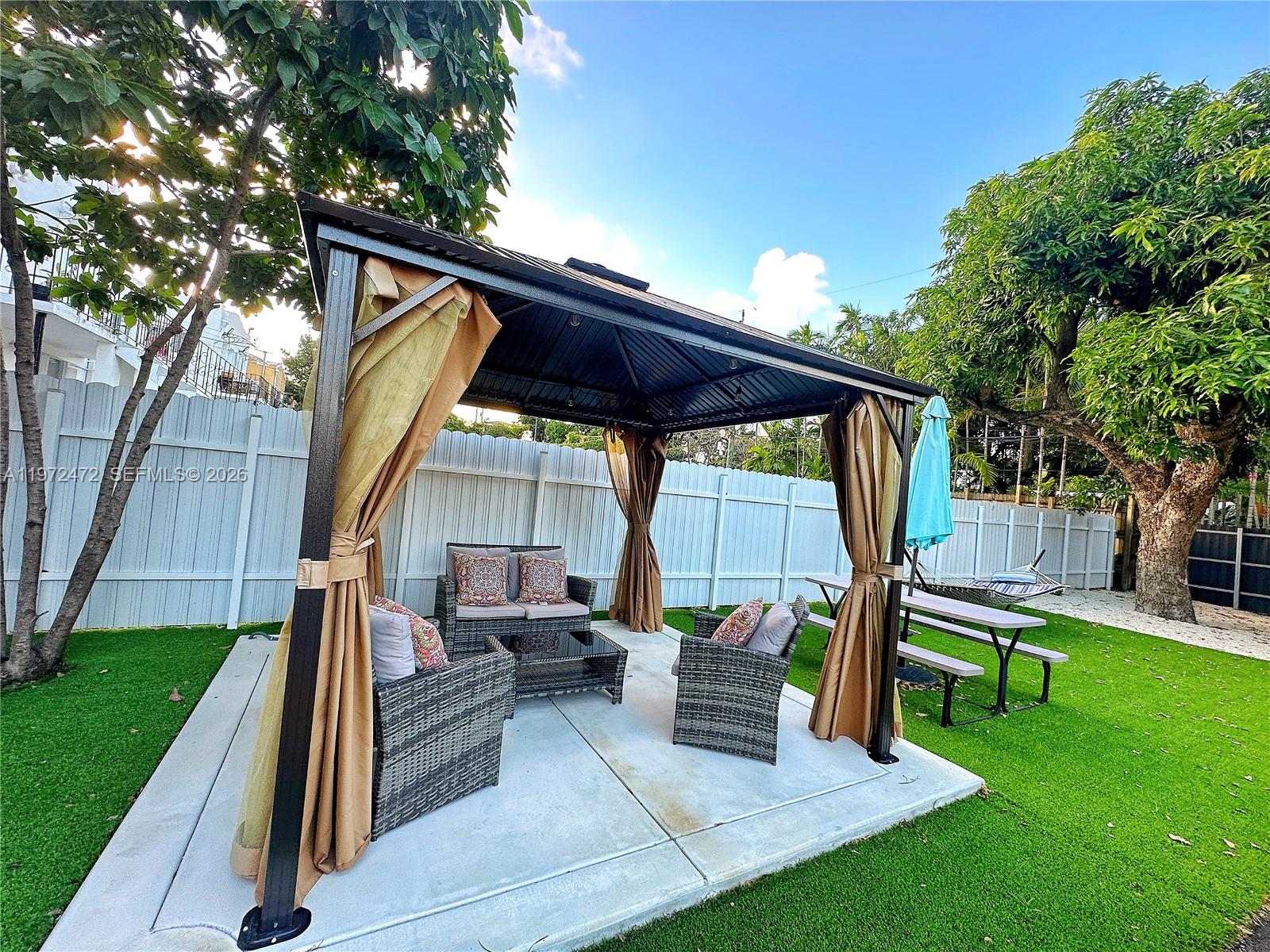 2153 Southwest 14th Terrace, Unit 4 Miami, FL 33145 - Photo 11 of 14 a backyard of a house with seating space