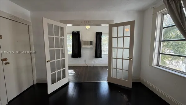 a hallway with windows and wooden floor