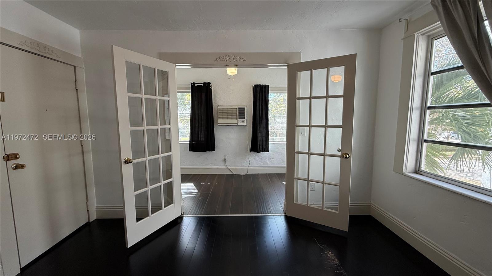 2153 Southwest 14th Terrace, Unit 4 Miami, FL 33145 - Photo 3 of 14 a hallway with windows and wooden floor