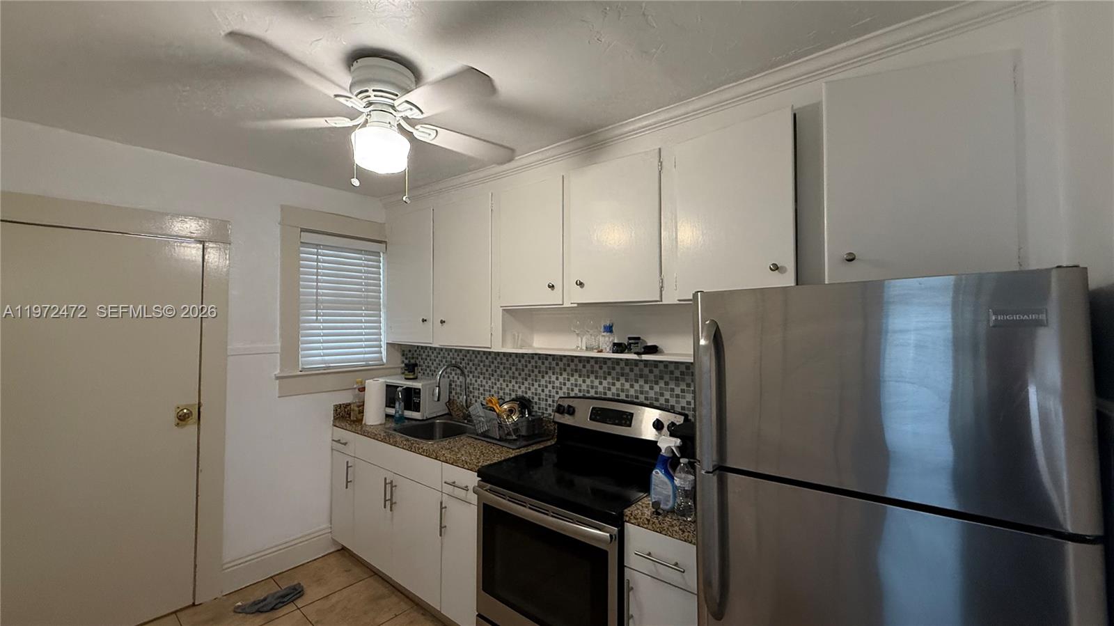 2153 Southwest 14th Terrace, Unit 4 Miami, FL 33145 - Photo 6 of 14 a kitchen with stainless steel appliances granite countertop a refrigerator a stove a sink and dishwasher