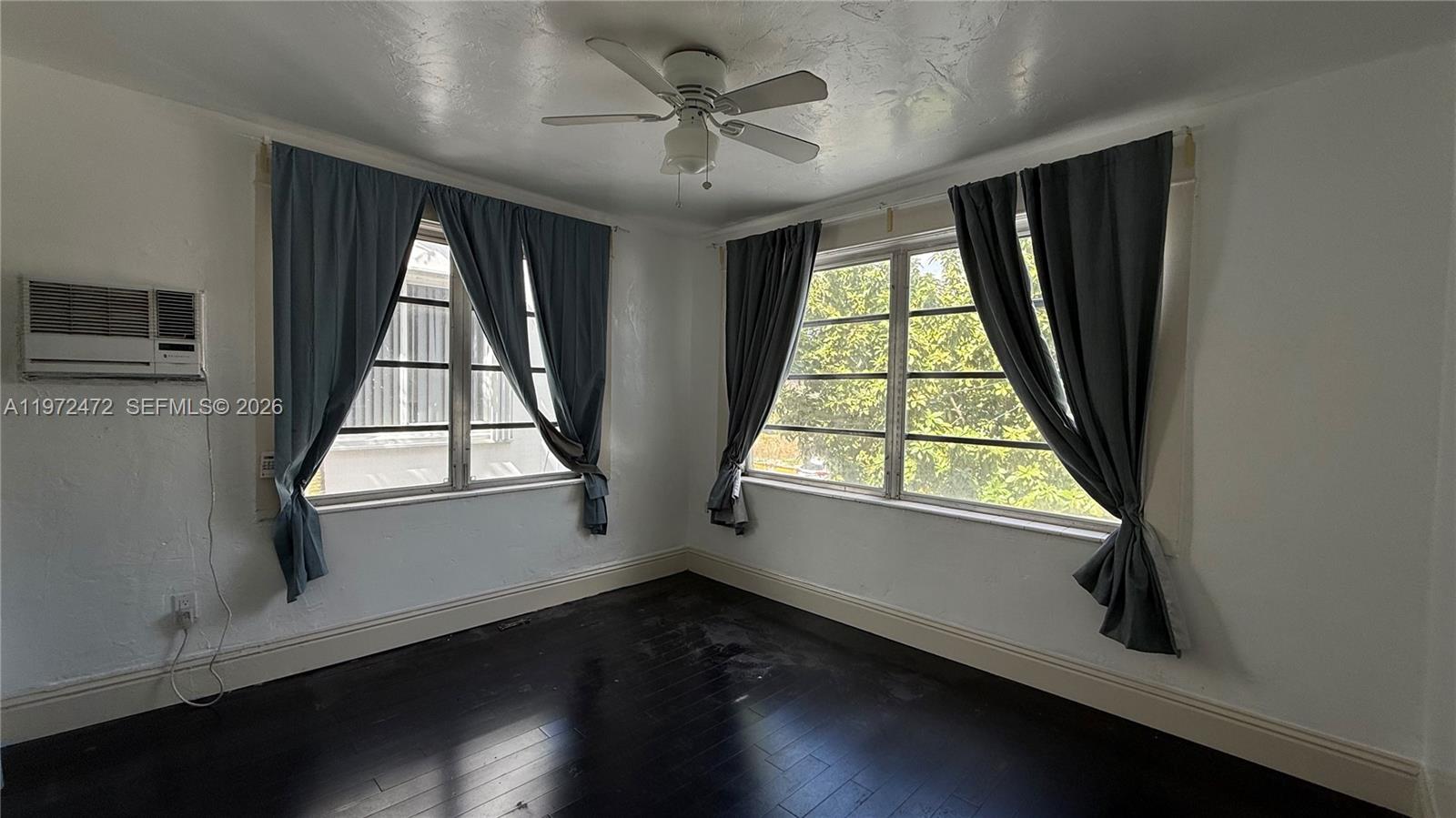 2153 Southwest 14th Terrace, Unit 4 Miami, FL 33145 - Photo 7 of 14 wooden floor in an empty room with a window