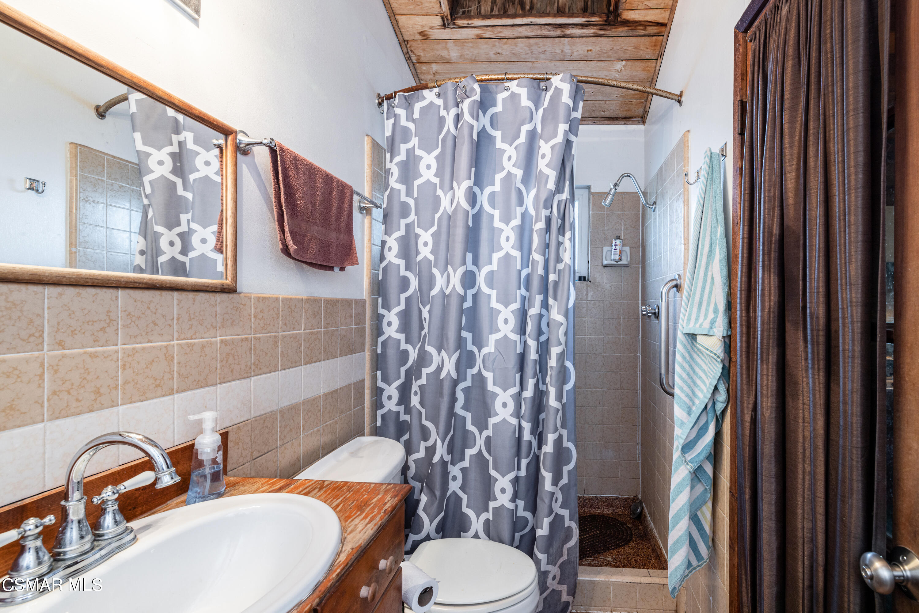1328 Olympic Street Simi Valley, CA 93063 - Photo 11 of 23 a bathroom with a toilet sink and shower curtain