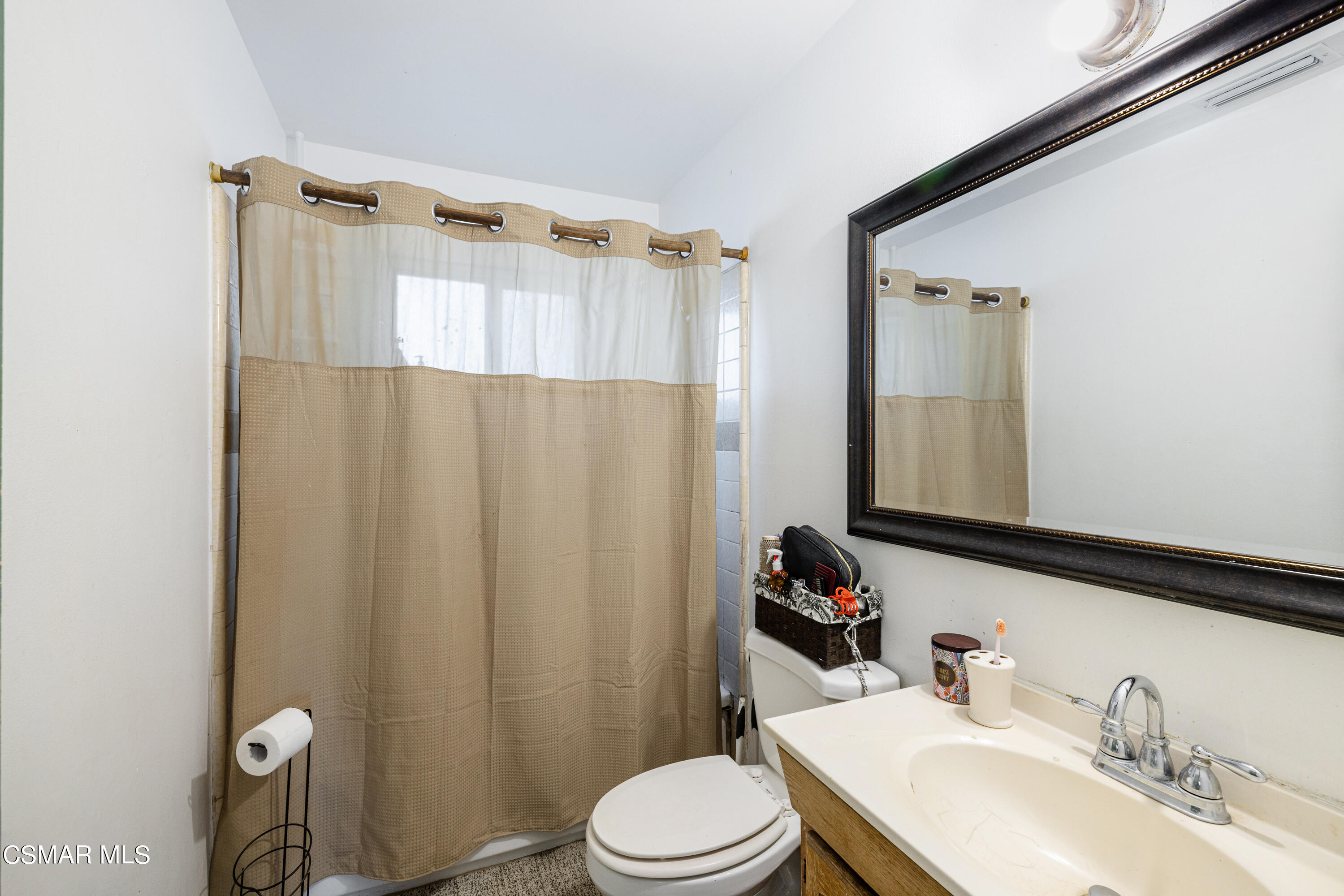 1328 Olympic Street Simi Valley, CA 93063 - Photo 13 of 23 a bathroom with a sink a toilet and shower curtain
