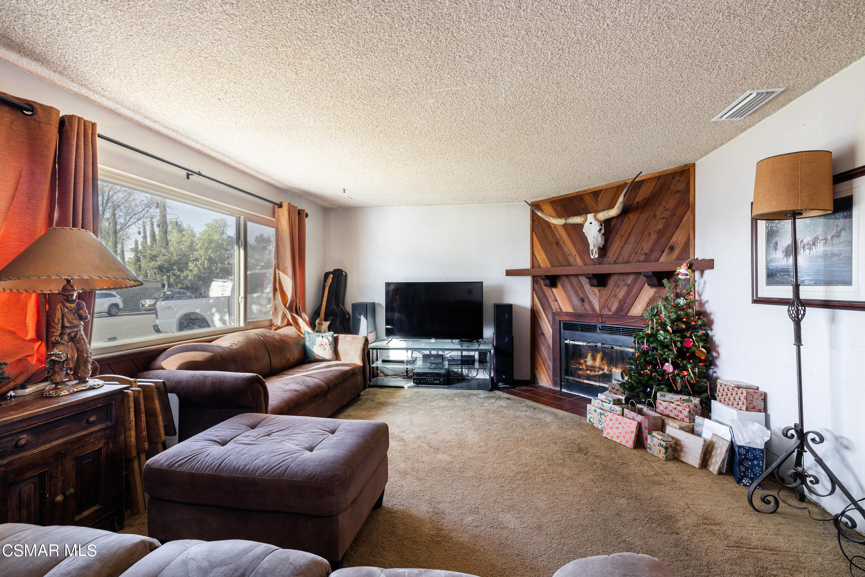 1328 Olympic Street Simi Valley, CA 93063 - Photo 4 of 23 a living room with furniture a flat screen tv and a floor to ceiling window