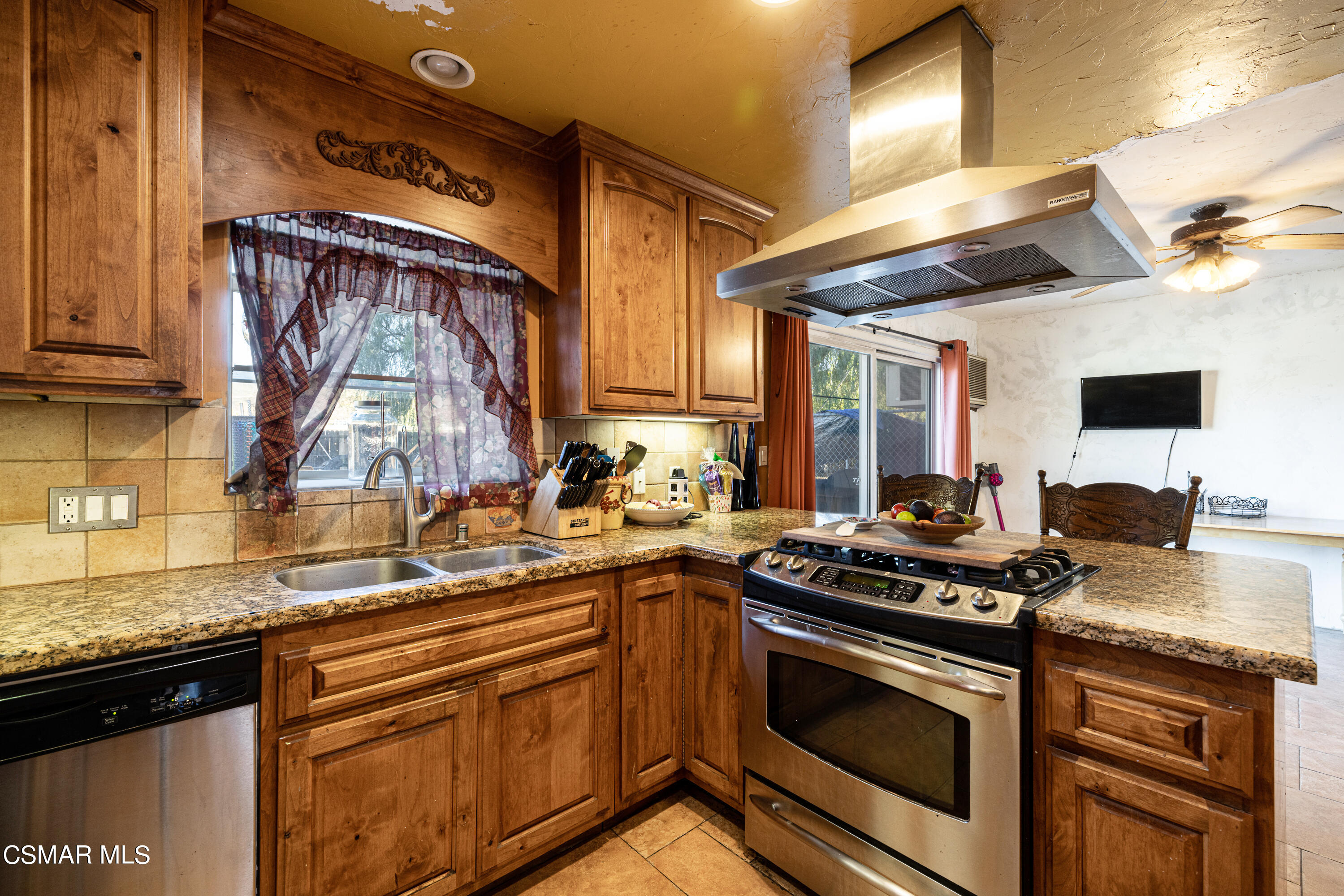 1328 Olympic Street Simi Valley, CA 93063 - Photo 7 of 23 a kitchen with stainless steel appliances granite countertop a stove and a sink