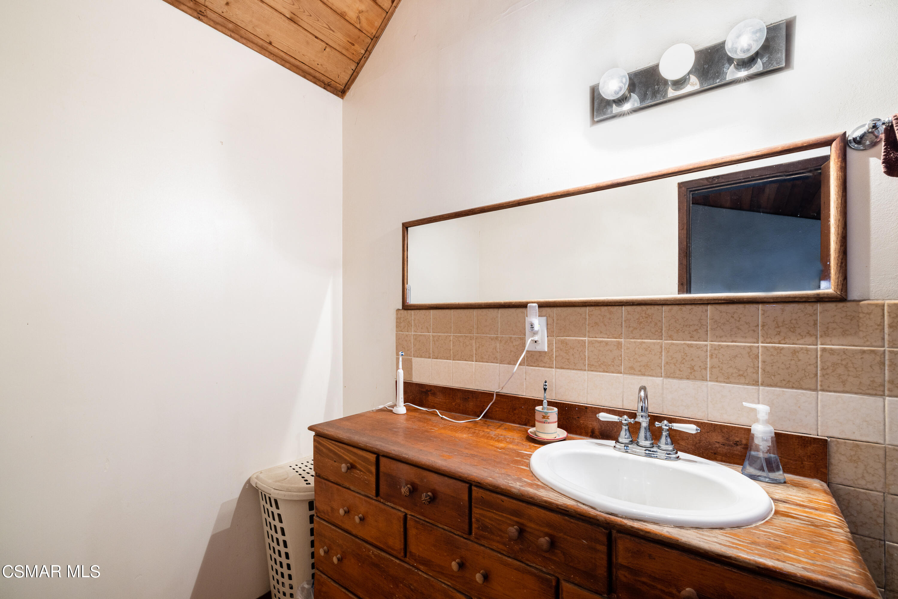 1328 Olympic Street Simi Valley, CA 93063 - Photo 10 of 23 a bathroom with a sink and a mirror