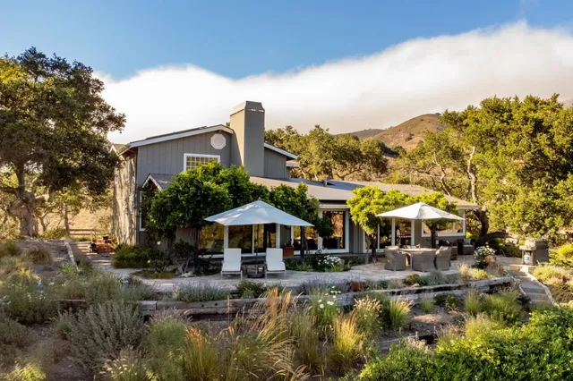 a backyard of a house with yard swimming pool and outdoor seating