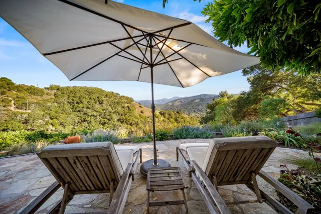 a view of table and chairs under an umbrella