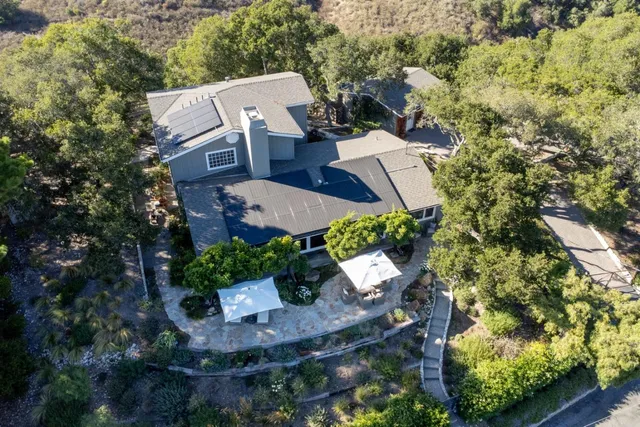 an aerial view of a house with garden space and street view