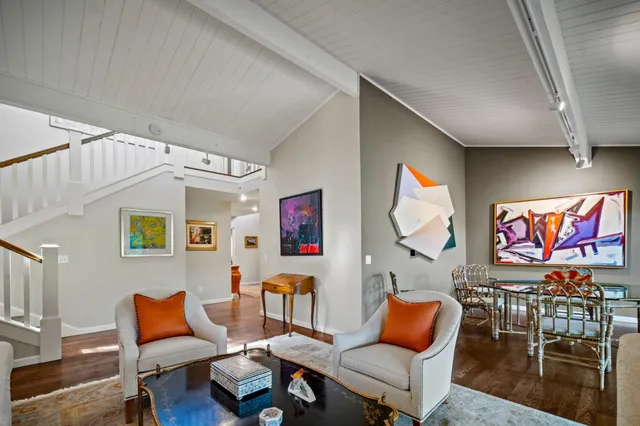 a living room with furniture and painting on the wall