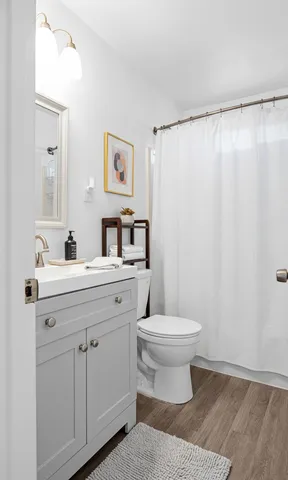 a bathroom with a sink toilet and shower