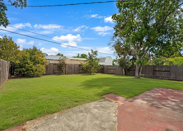 a view of a garden with a building in the background