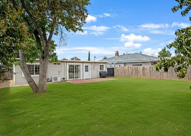 a view of a house with a backyard