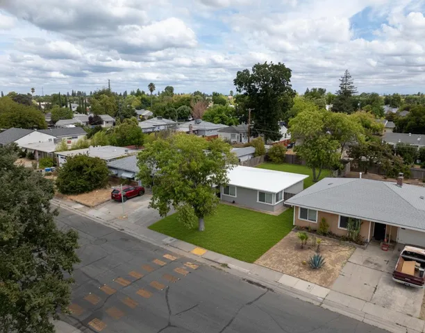 an aerial view of a house with yard swimming pool and mountain view in back