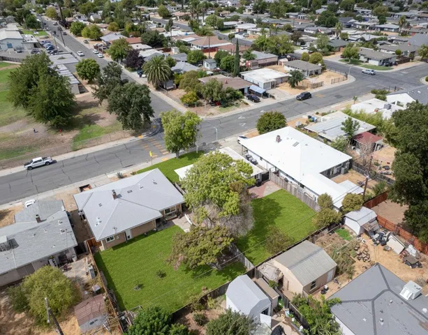 an aerial view of a house with a yard