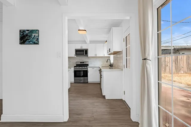 a kitchen with stainless steel appliances a refrigerator and a stove top oven