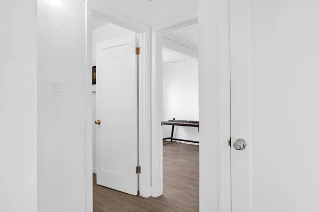 a view of a hallway with wooden floor
