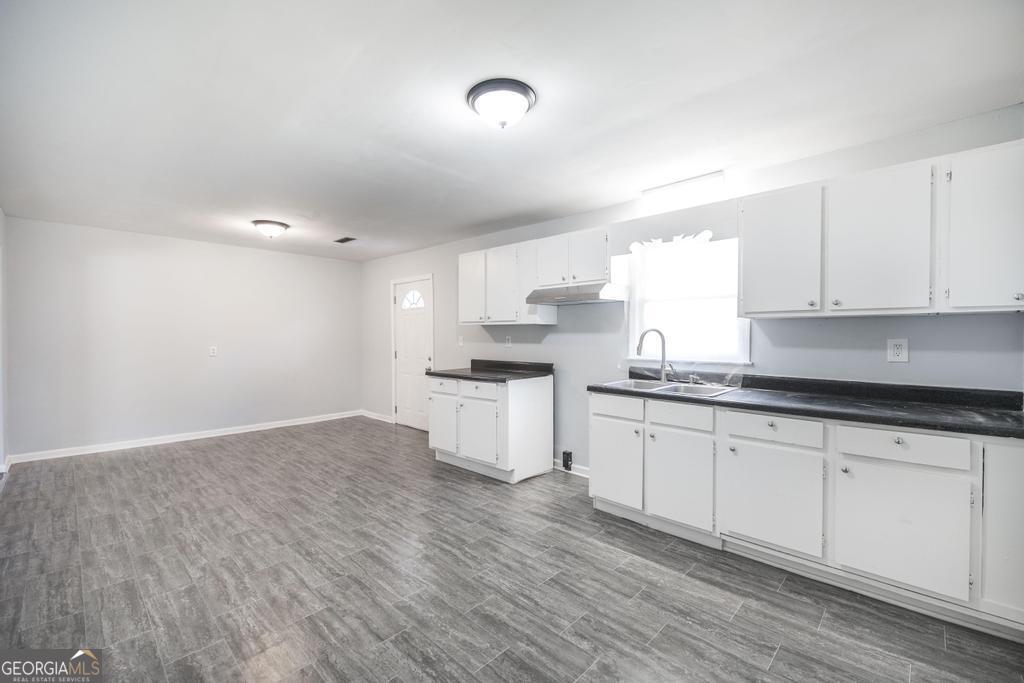 918 Henderson Street Dublin, GA 31021 - Photo 14 of 23 a kitchen with granite countertop white cabinets and white appliances