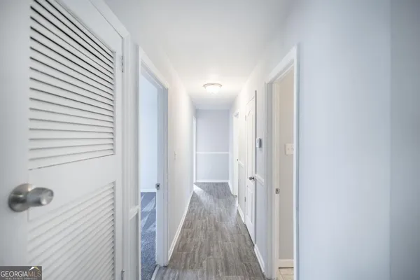 a view of a hallway with wooden floor