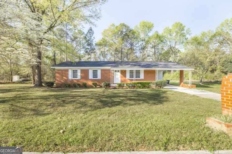 918 Henderson Street Dublin, GA 31021 - Photo 2 of 23 a view of a house with a yard and sitting area