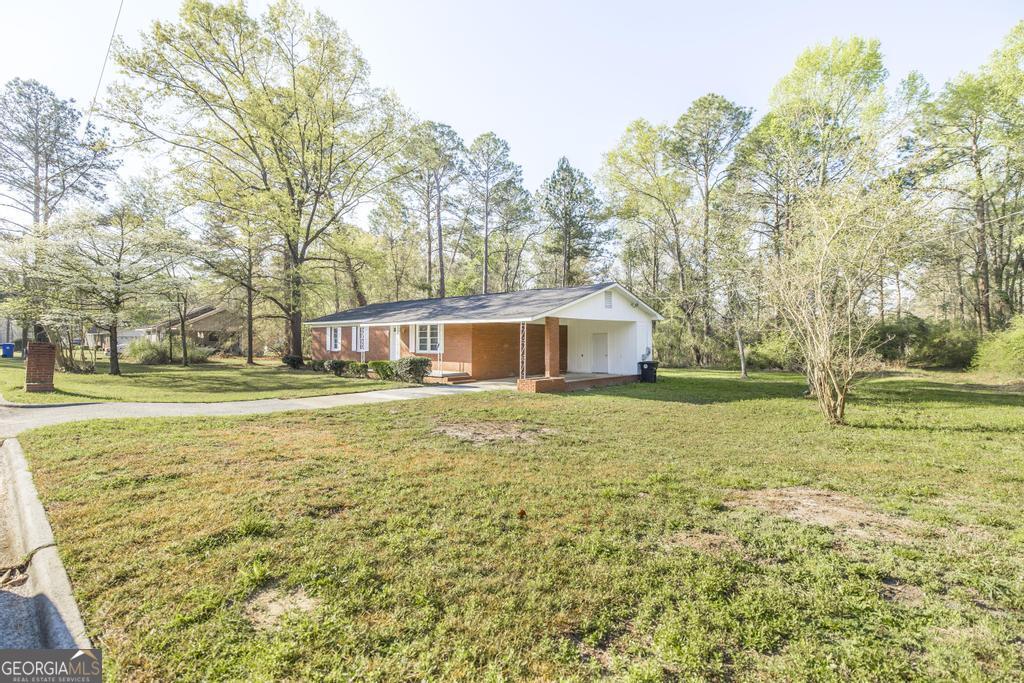 918 Henderson Street Dublin, GA 31021 - Photo 3 of 23 a front view of a house with a yard