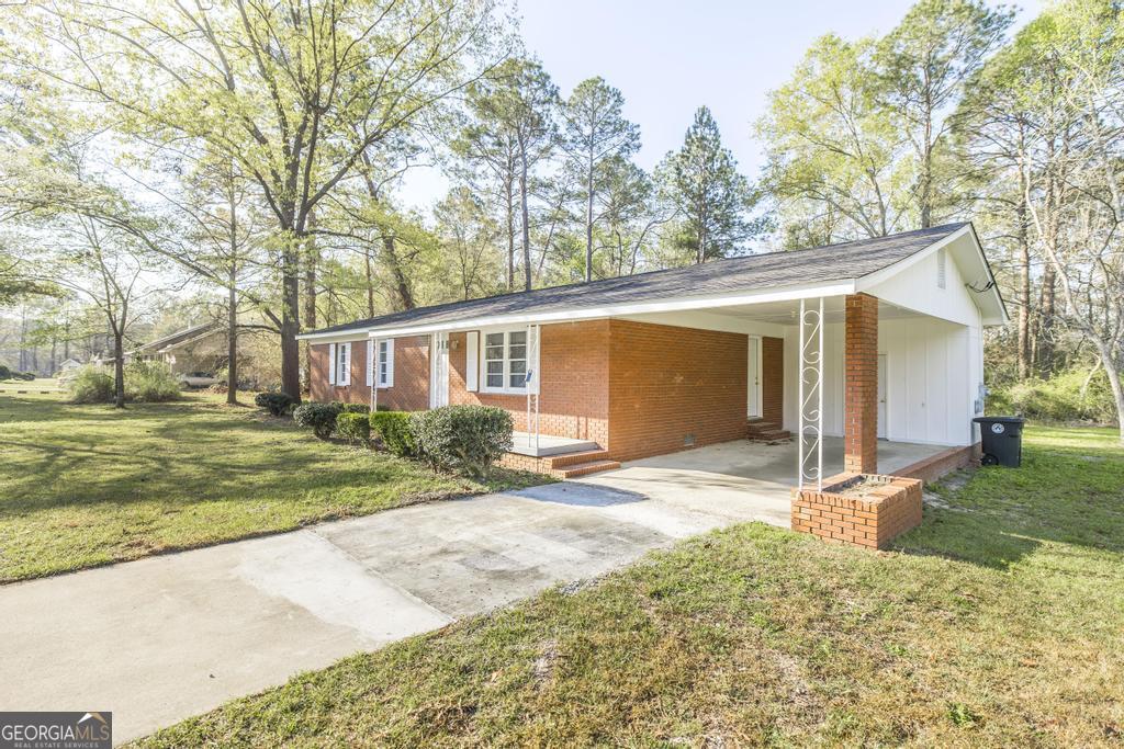 918 Henderson Street Dublin, GA 31021 - Photo 4 of 23 front view of a house with a yard