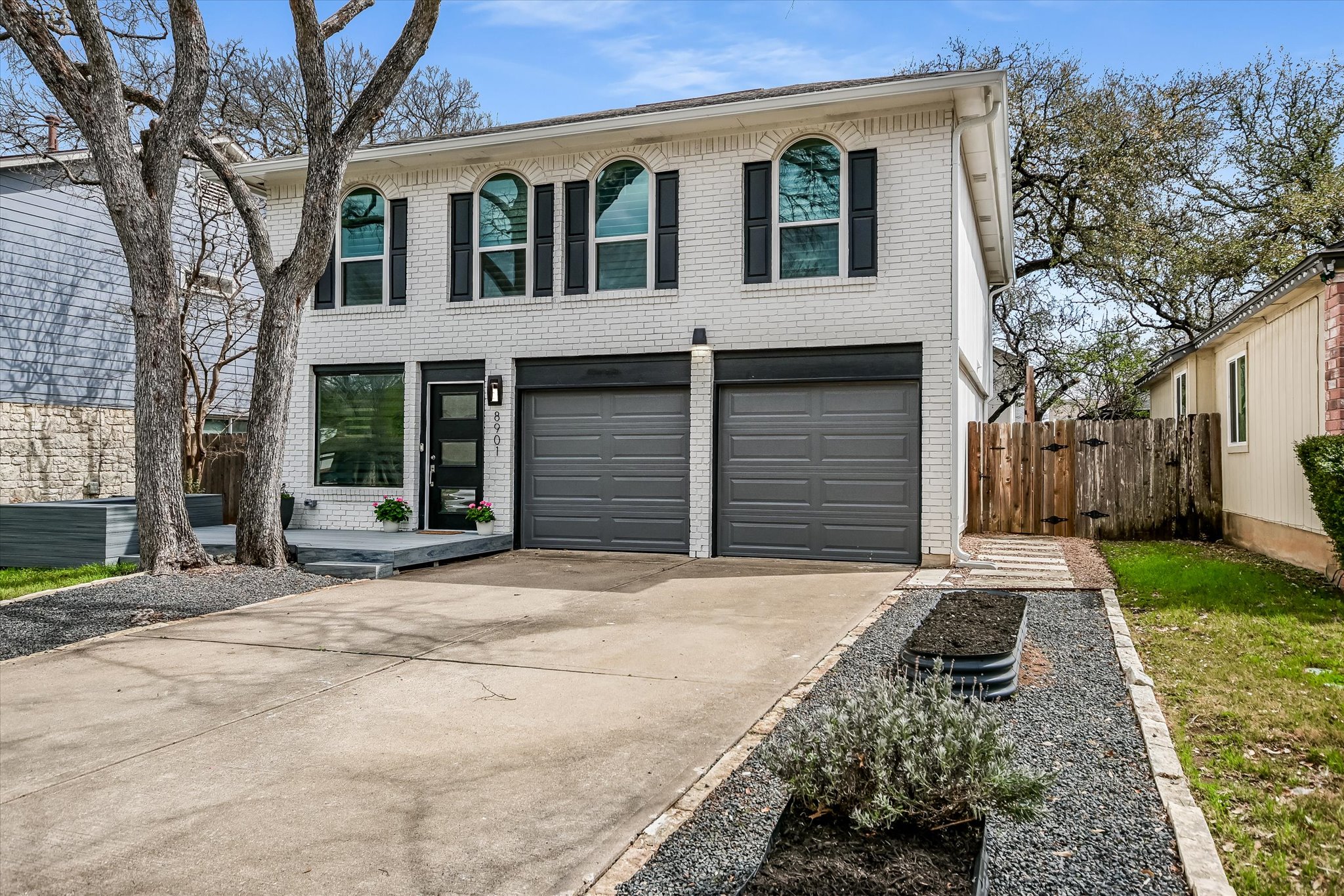 8901 Ampezo Trail Austin, TX 78749 - Photo 1 of 1 View of front of property featuring brick siding, driveway, an attached garage, and a gate