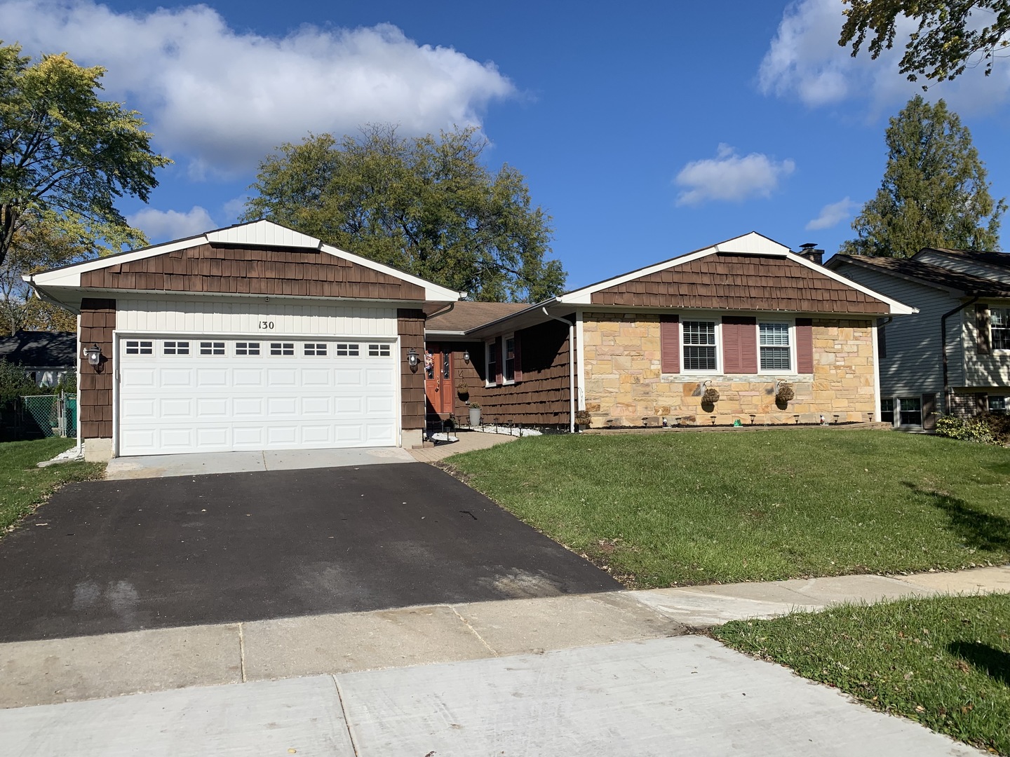 130 Stonegate Road Buffalo Grove, IL 60089 - Photo 1 of 13 a front view of a house with a yard