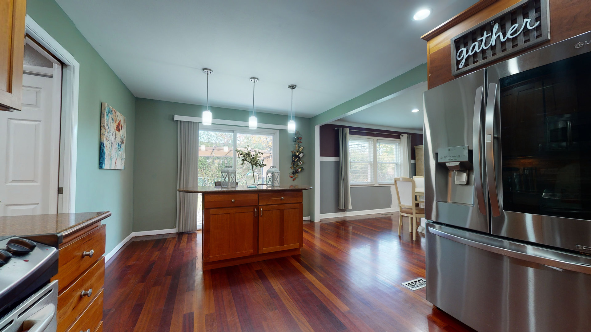 130 Stonegate Road Buffalo Grove, IL 60089 - Photo 3 of 13 a open kitchen with wooden floor and stainless steel appliances