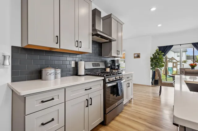 a view of a workspace with furniture and wooden floor