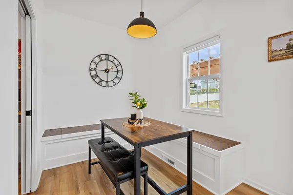 a view of a livingroom with wooden floor and stairs
