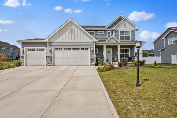 a front view of a house with a yard and a garage