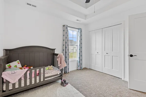 a bedroom with a bed and a dresser