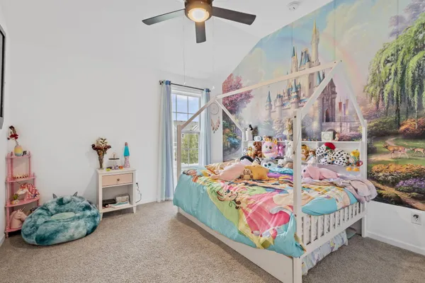 a view of walk in closet with clothes