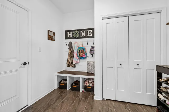 a view of a swimming pool with a bench and lawn chairs