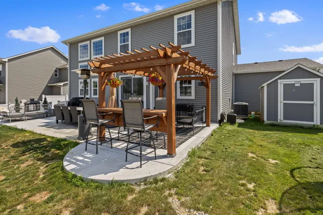 an aerial view of a house with swimming pool and outdoor seating