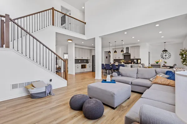 a kitchen with stainless steel appliances white cabinets and a refrigerator