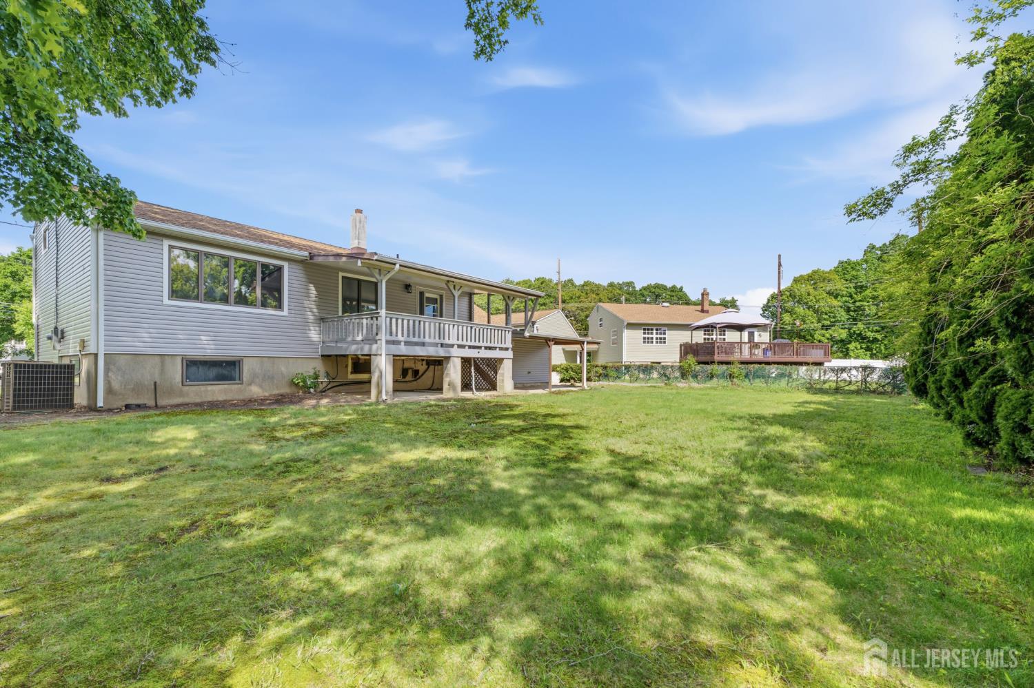 12 Daniel Road Spotswood, NJ 08884 - Photo 25 of 27 a view of a big house with a big yard and large trees