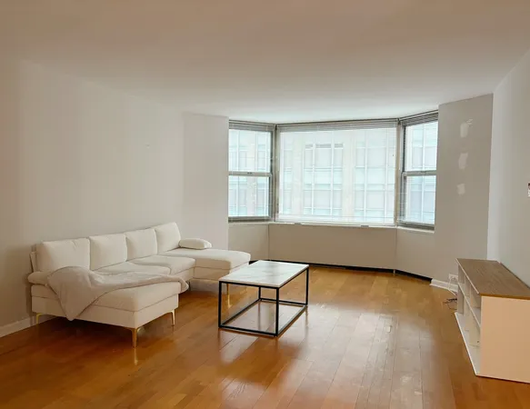 a living room with a couch and chandelier