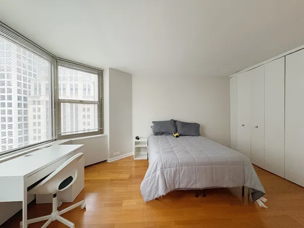a bedroom with a bed and a window