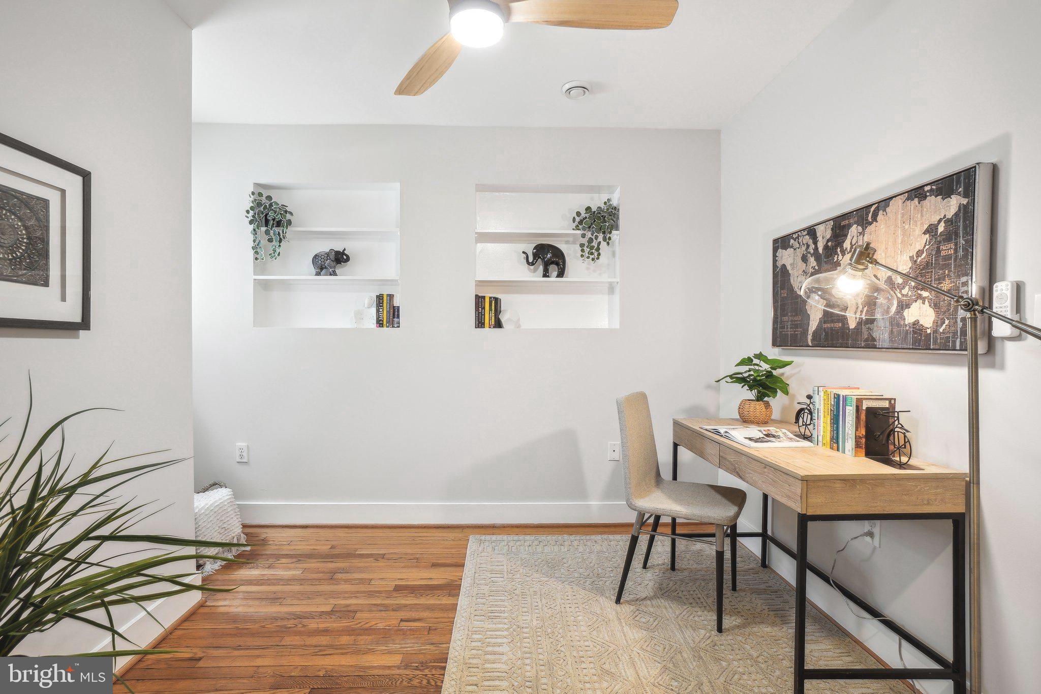 708 5th Street Southeast Washington, DC 20003 - Photo 15 of 25 a workspace with furniture and painting on the wall