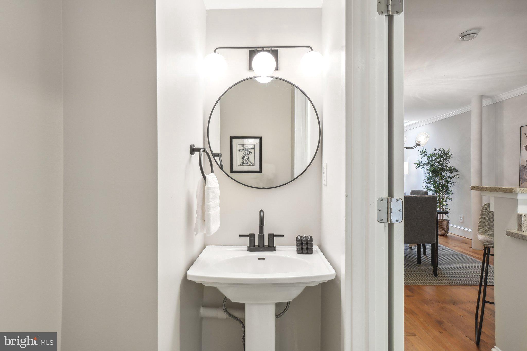 708 5th Street Southeast Washington, DC 20003 - Photo 8 of 25 a bathroom with a sink and a mirror